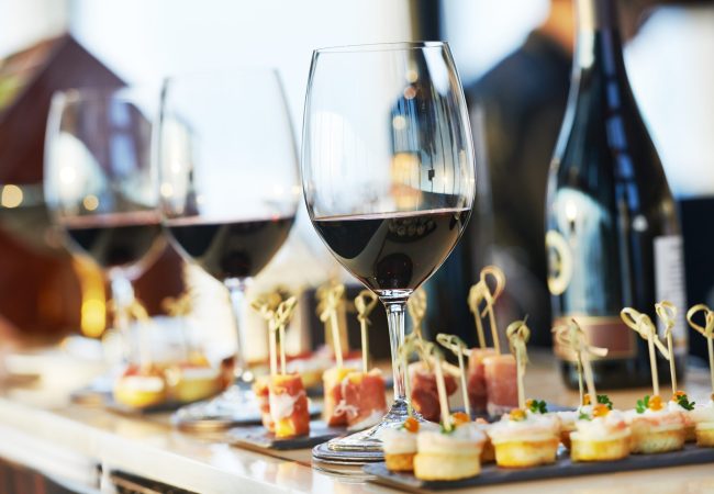 catering services background with snacks and glasses of wine on bartender counter in restaurant